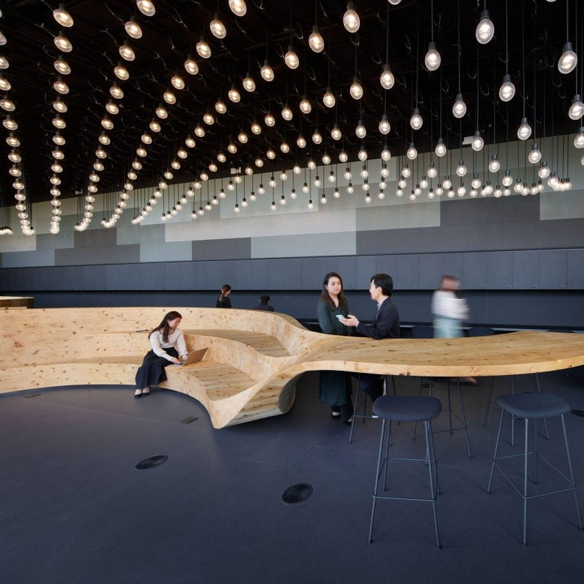 Co-working space with suspended light fittings and wooden furniture