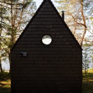 Cabin clad with black shingles
