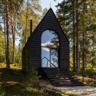 A black woodland cabin