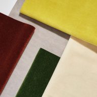 Dedar's Vladimiro velvet laid out in sheets of different colours including yellow and maroon