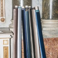 Dedar's Romeo & Giulietta fabrics in varying shades of blue and grey rolled up against a wall