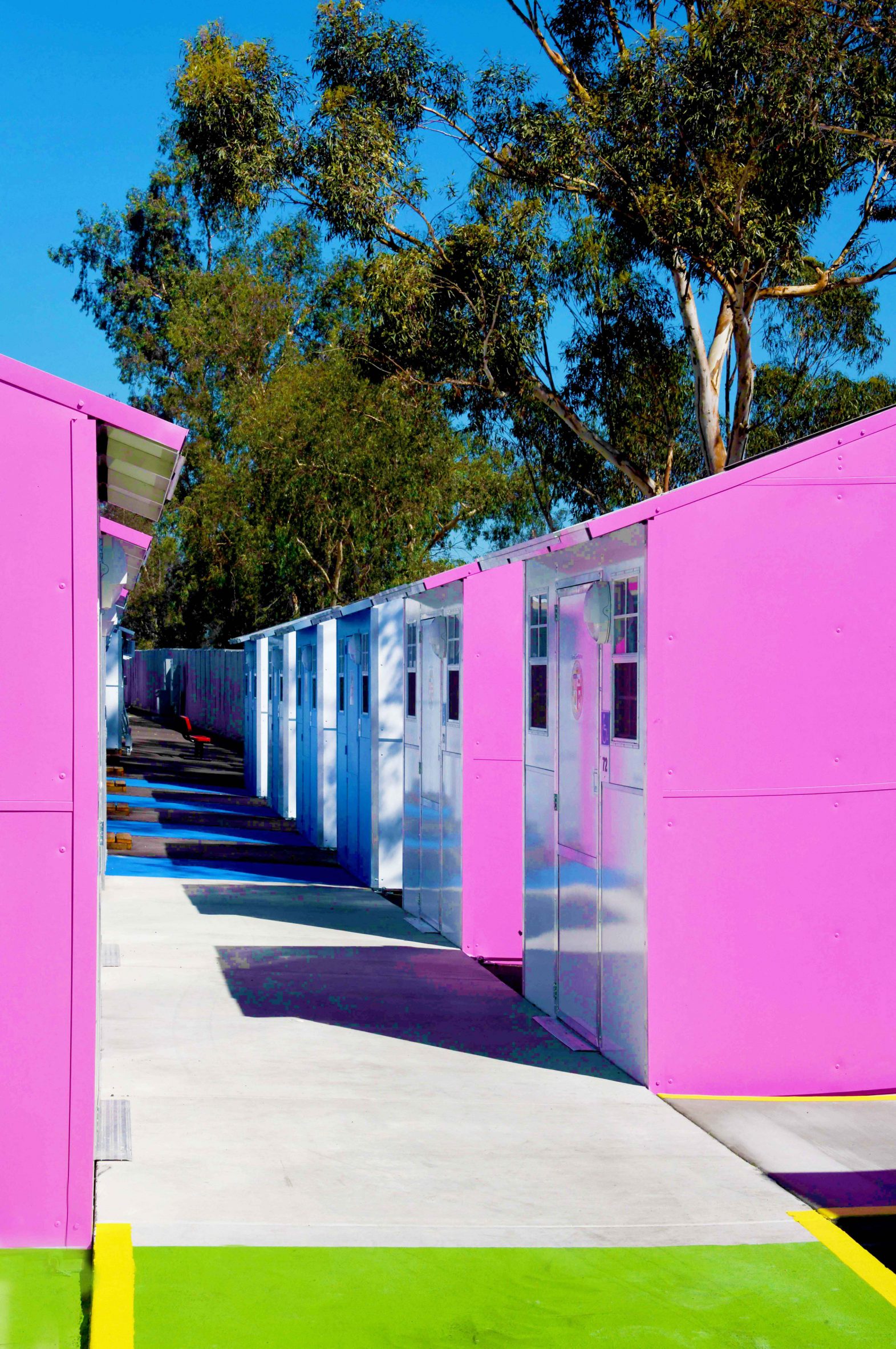 Pink-sided units at Whitsett West Tiny Home Village