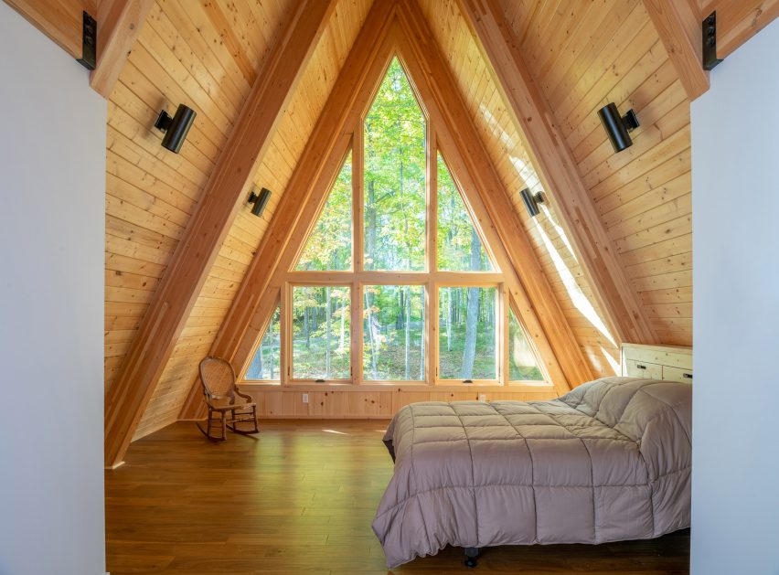 A bedroom at the top of a cabin