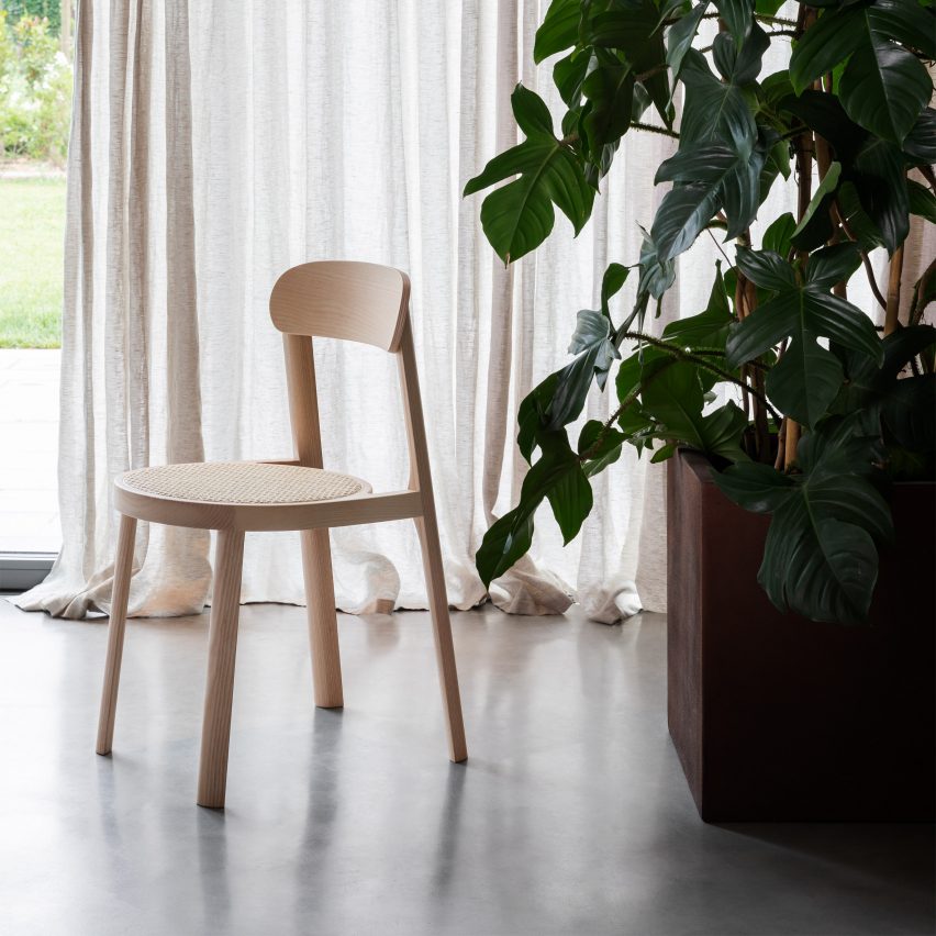 A photograph of the Brulla chair in front of a sheer curtain