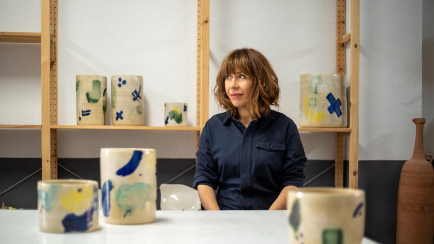 Ceramicist Ana Illueca in her studio next to colourful pottery