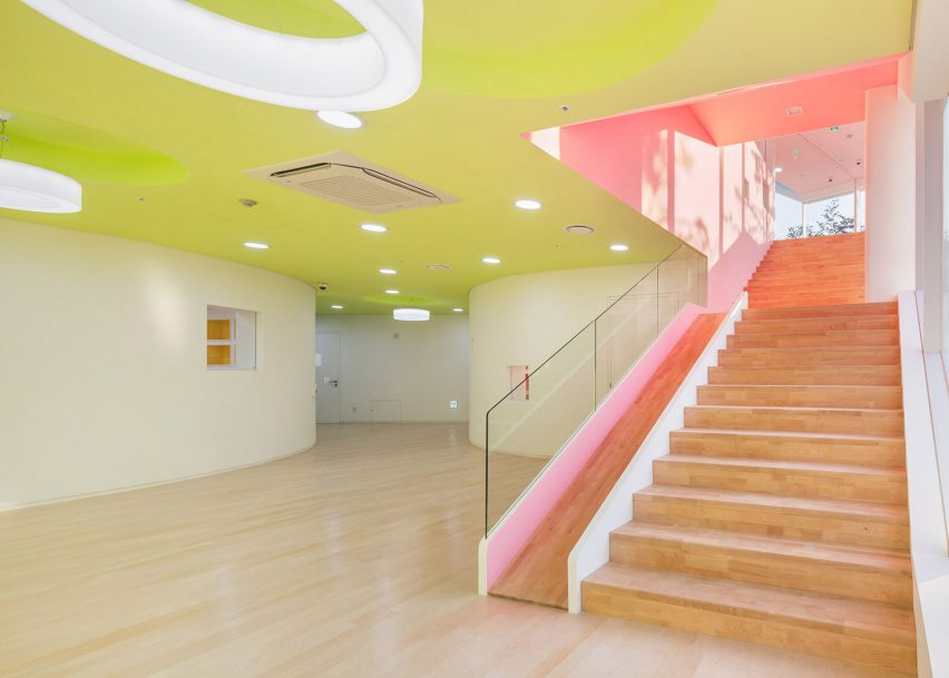 A kindergarten with a yellow ceiling and pink slide