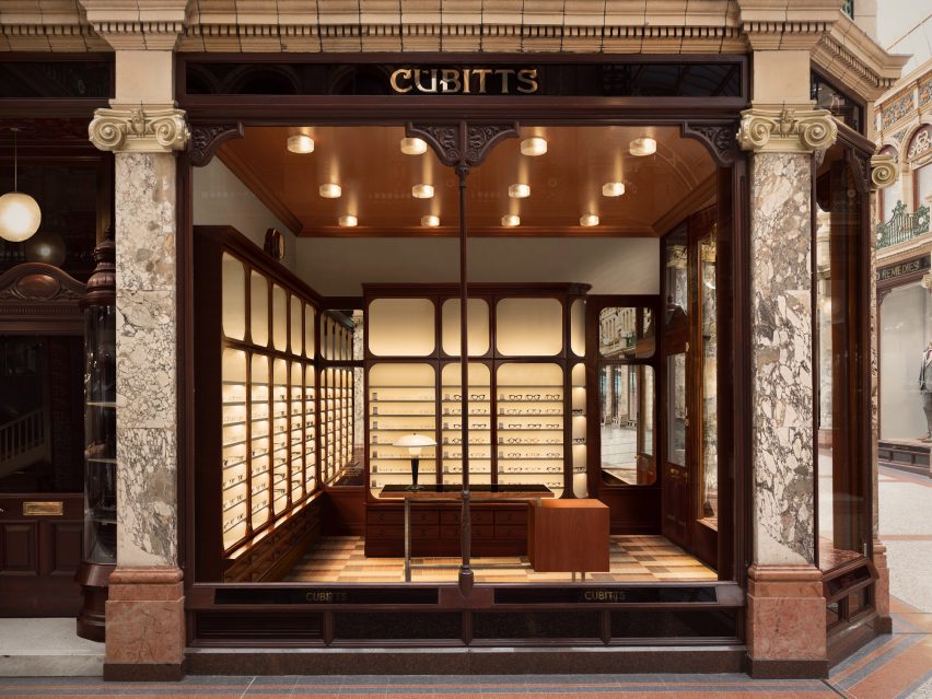 Exterior view of Cubitts store in Leeds flanked by pink marble columns with gilded glass logo