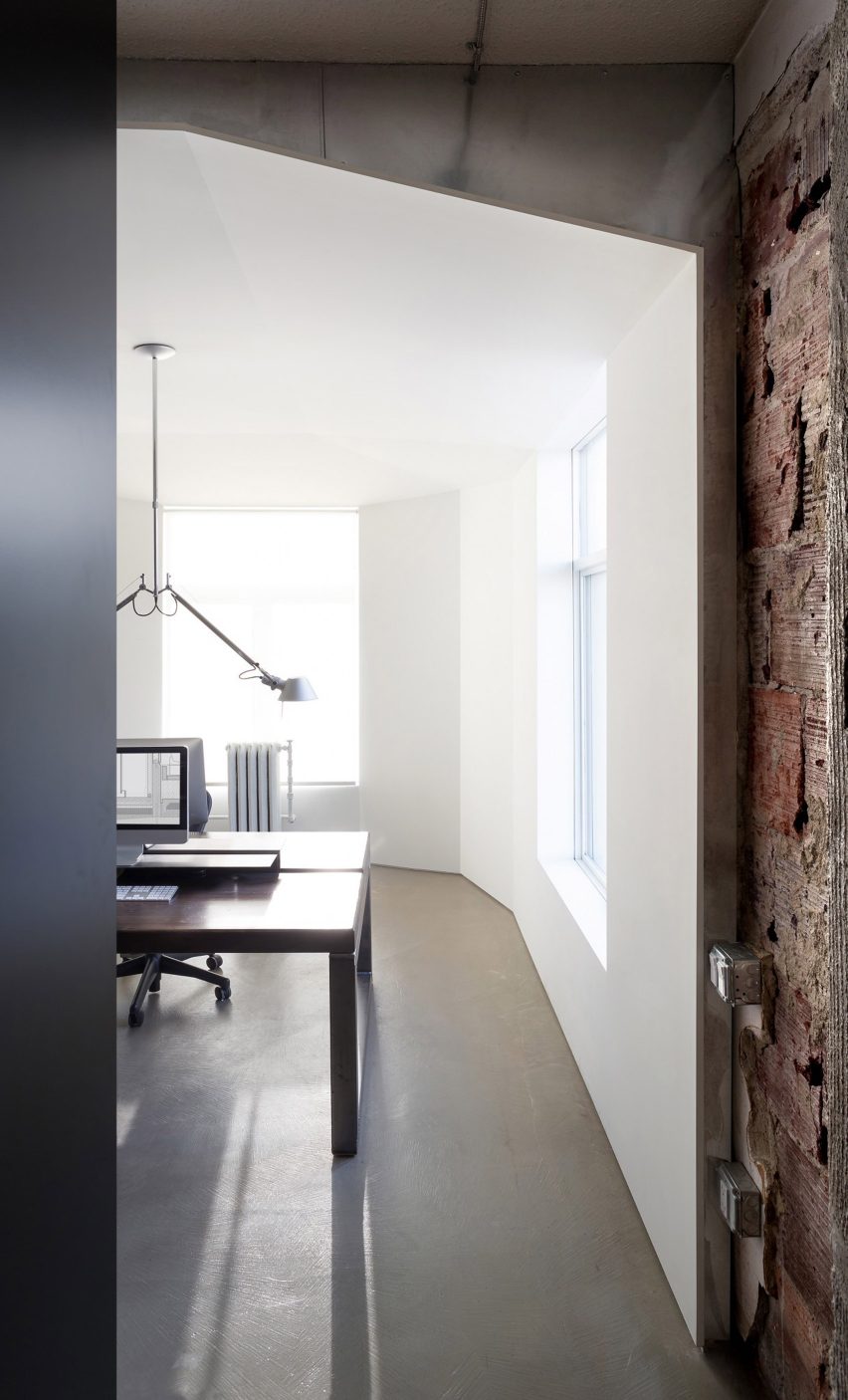 Detail shot of D'Arcy Jones Architects' self-designed studio showing white drywall next to original brick 