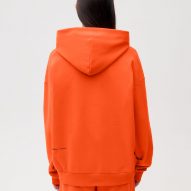 A model wearing Es Devlin's orange clothing for Pangaia