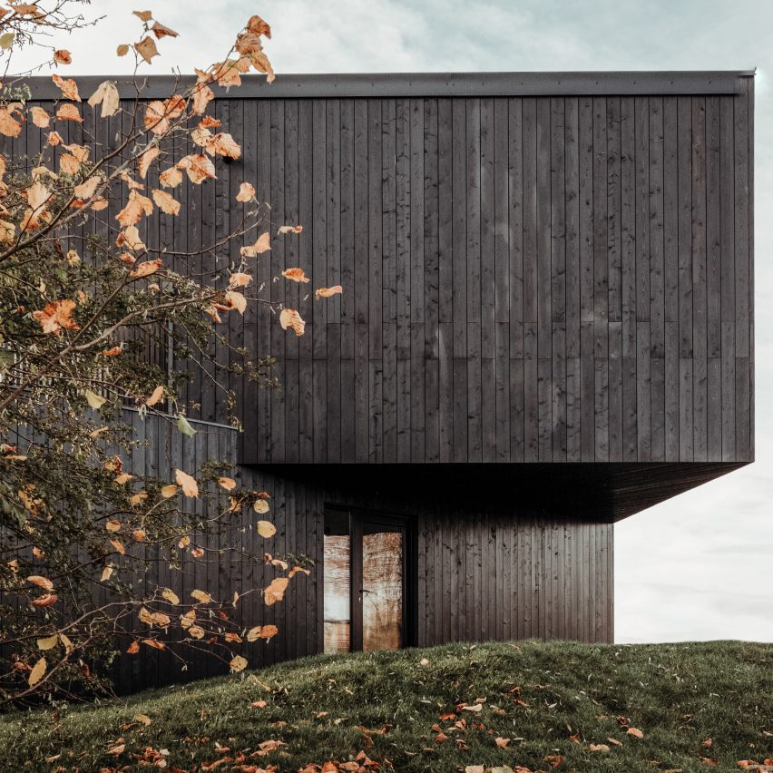 A black timber prefabricated home by Koto