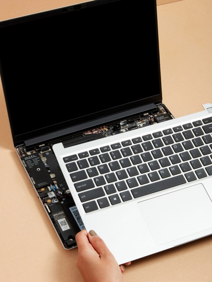 Hands removing the keyboard from a Framework laptop