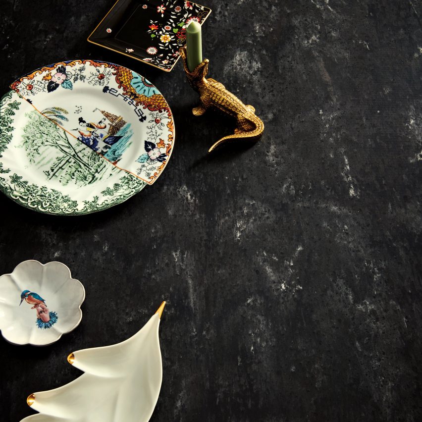 A close view of the black Aurora surface with decorative ceramics featured on Dezeen Showroom