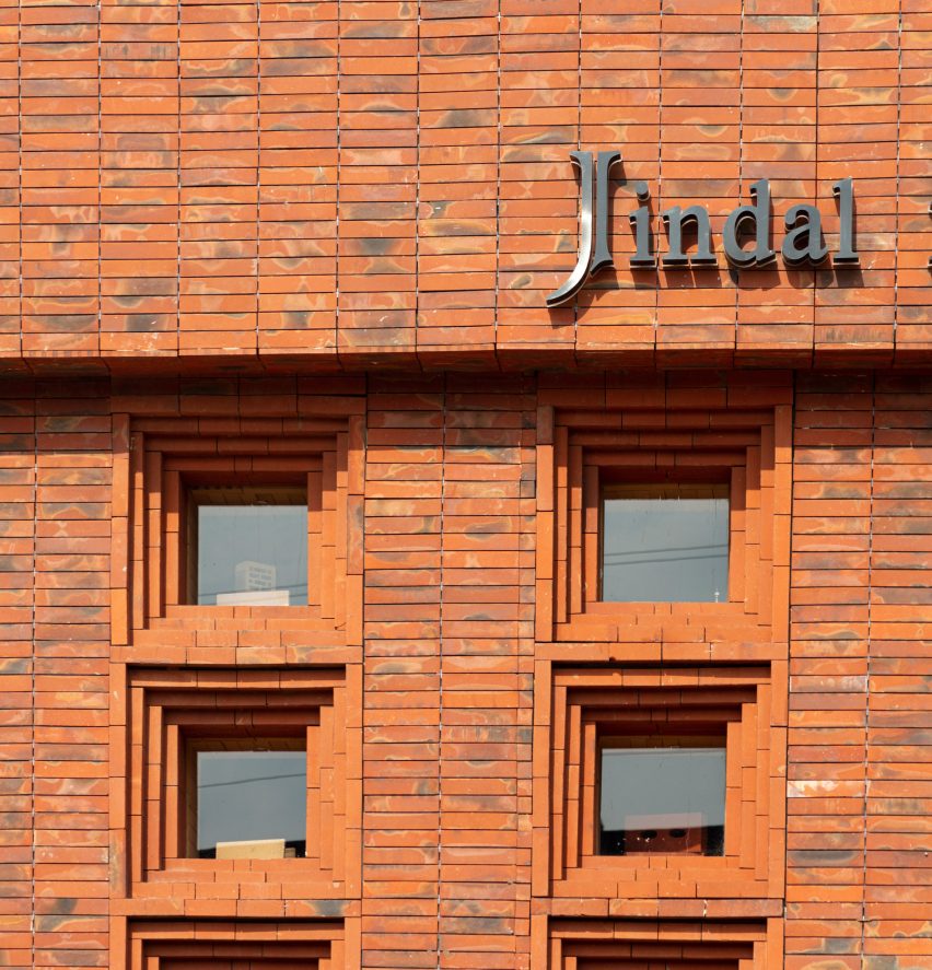 Exterior of Indal Mechno Bricks showroom in New Delhi with brick facade, square windows and black logo sign
