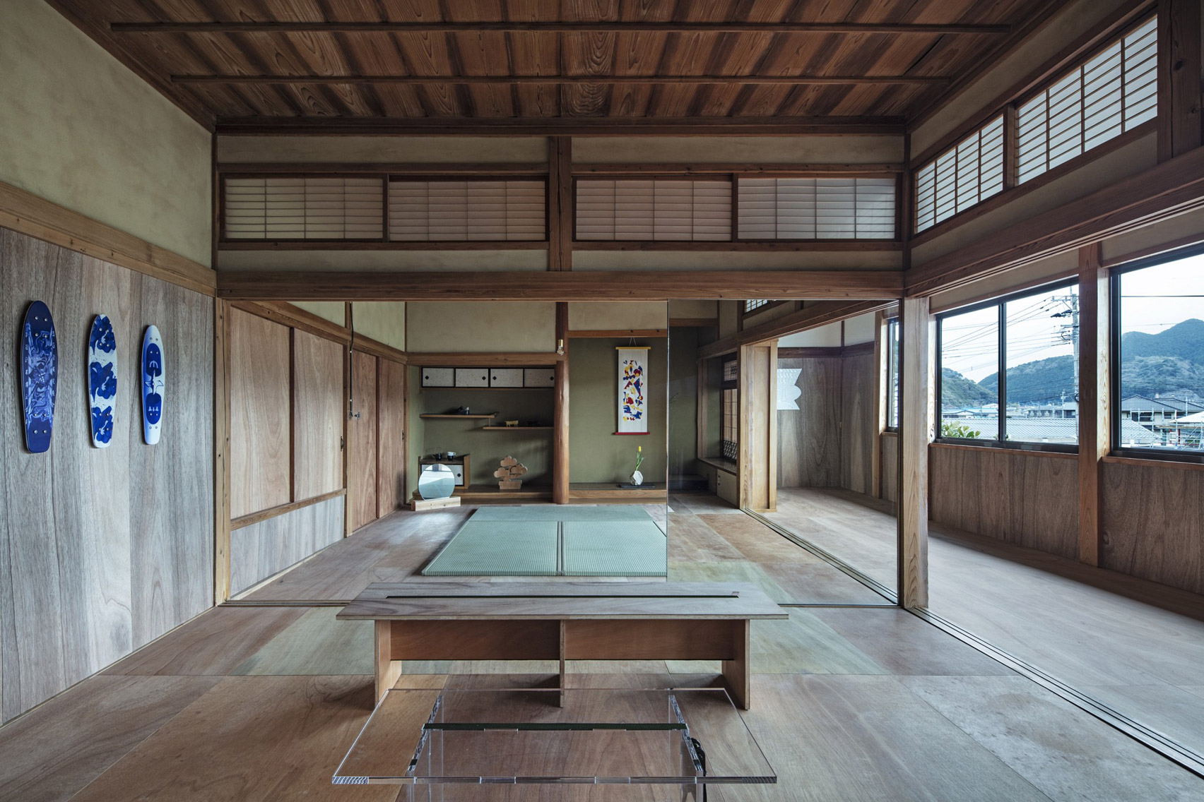 Artists workshop with wooden flooring in traditional Japanese house converted into office by DDAA Inc
