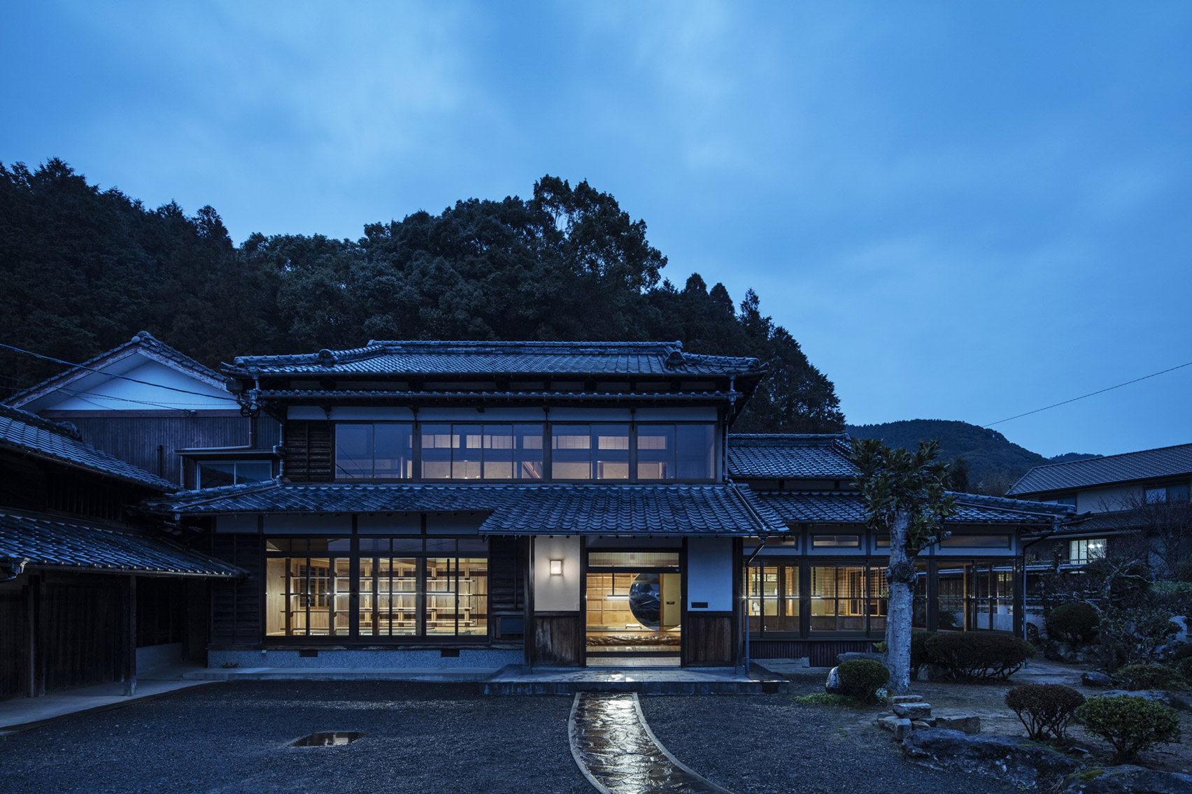 Exterior of Maruhiro office in converted Japanese house at dusk