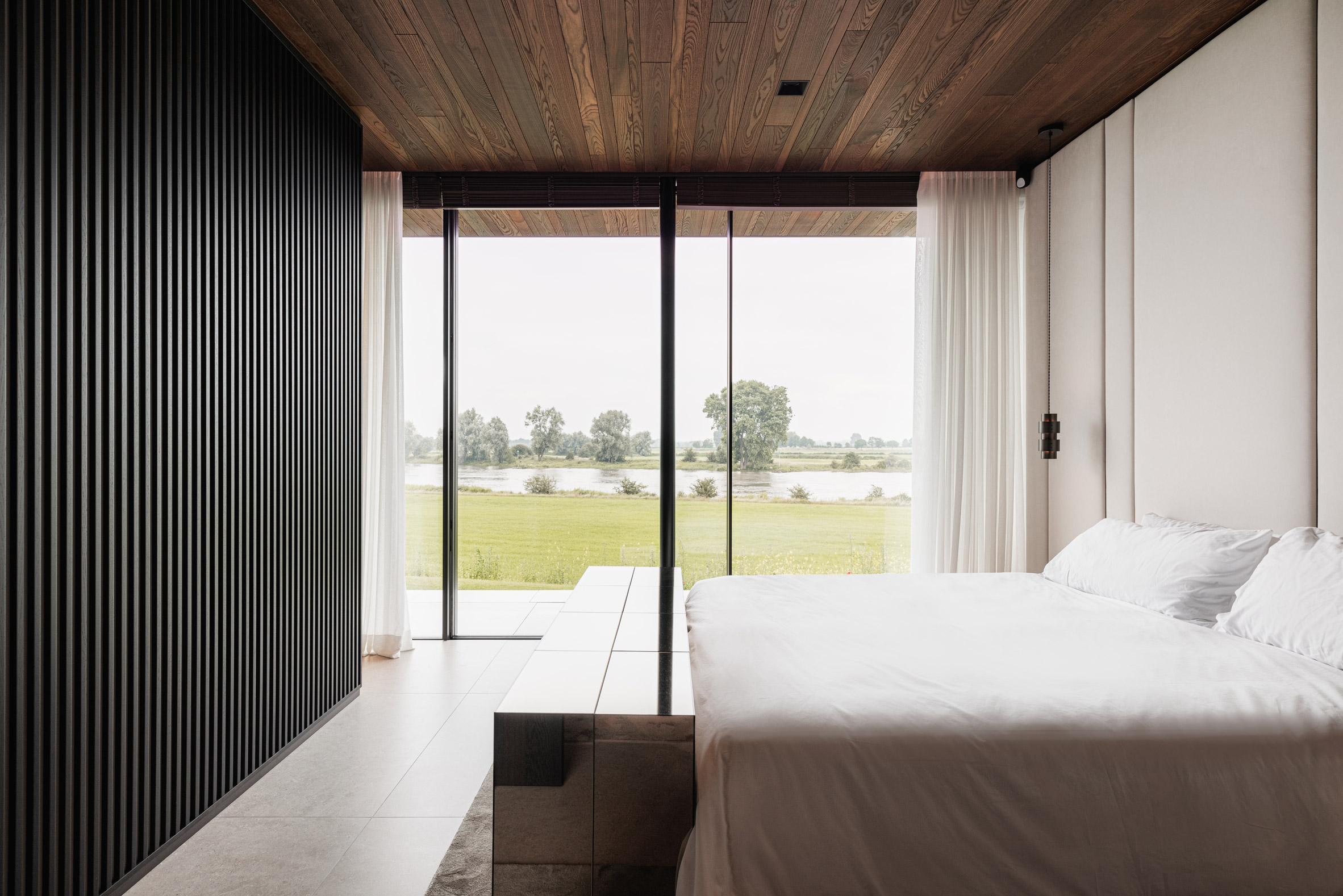 Bedroom of Modern House by the River by Maas Architecten