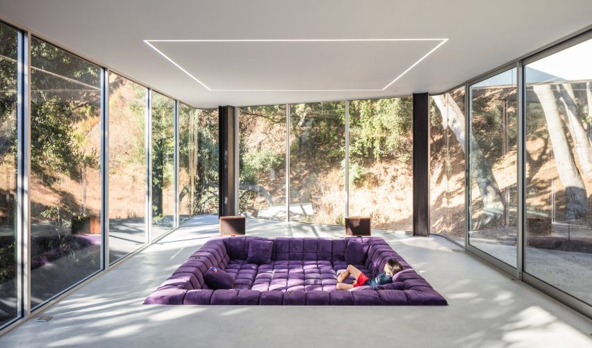 A purple sofa integrated into the living room floor