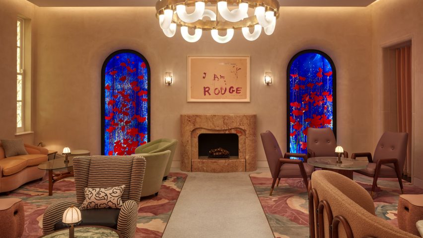 Interior of The Red Room bar in The Connaught hotel, London with stained-glass panels by Brian Clarke framing a marble fireplace