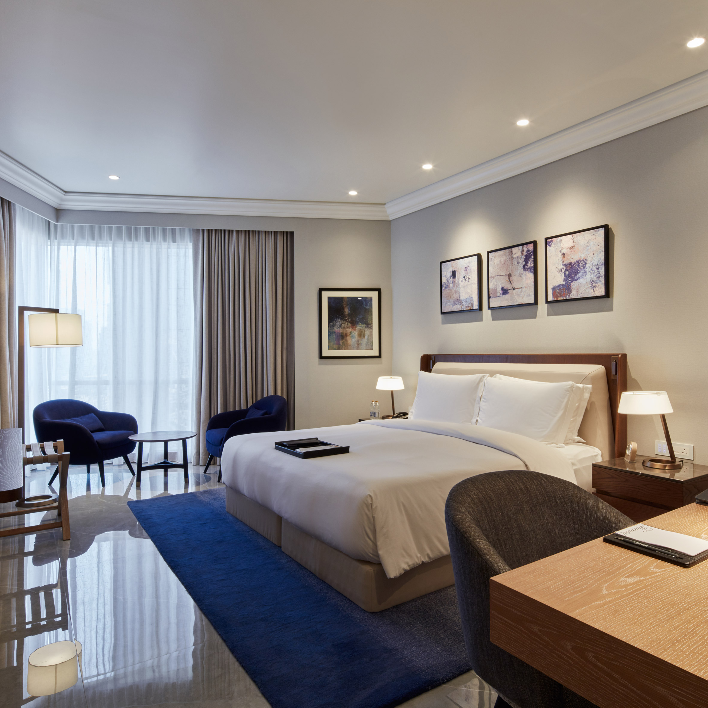 A photograph of a bedroom within one of the Fairmont Dubai's rooms