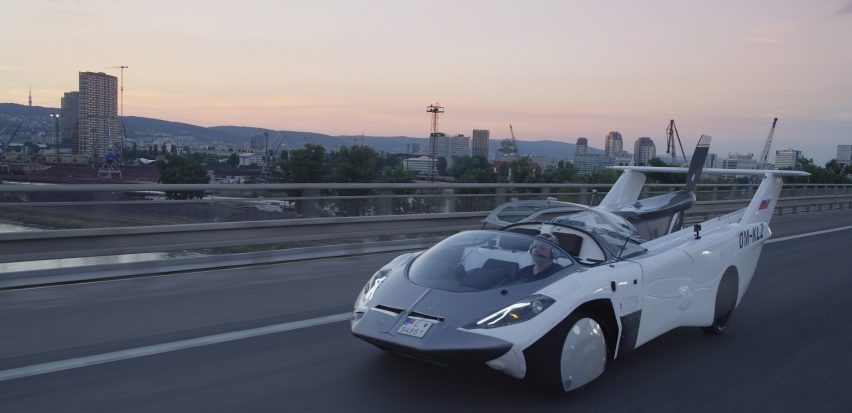 White AirCar vehicle in sportscar mode drives on a highway