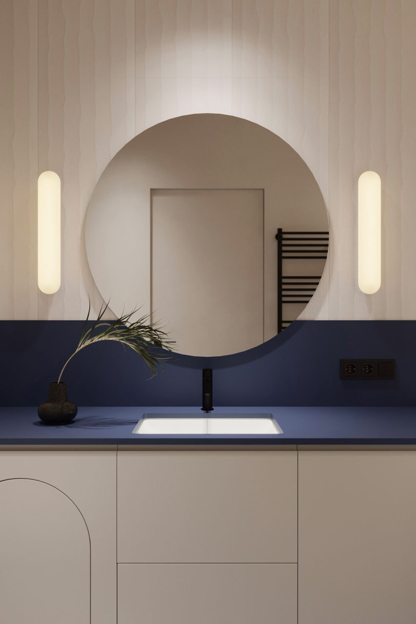 Altea wall light by Astro Lighting around a circular bathroom mirror