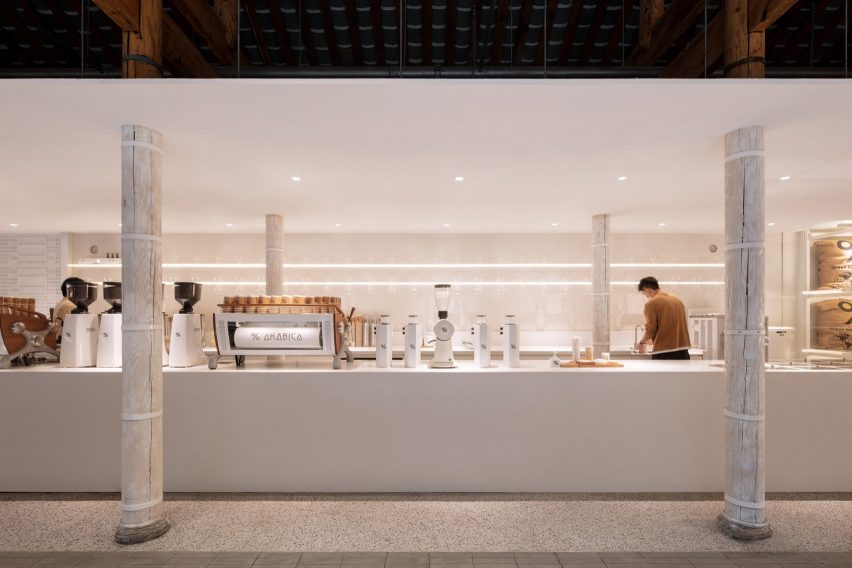 Long white counter surrounded by white pillars in % Arabica coffee shop in Chengdu