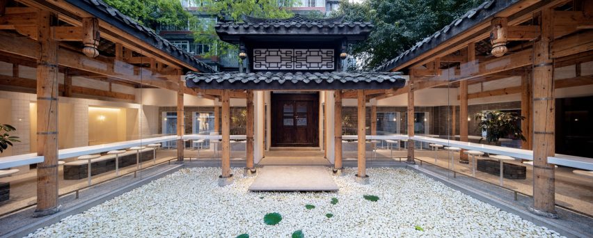 Central courtyard of Kuanzhai Alley coffee shop filled with pebbles and water