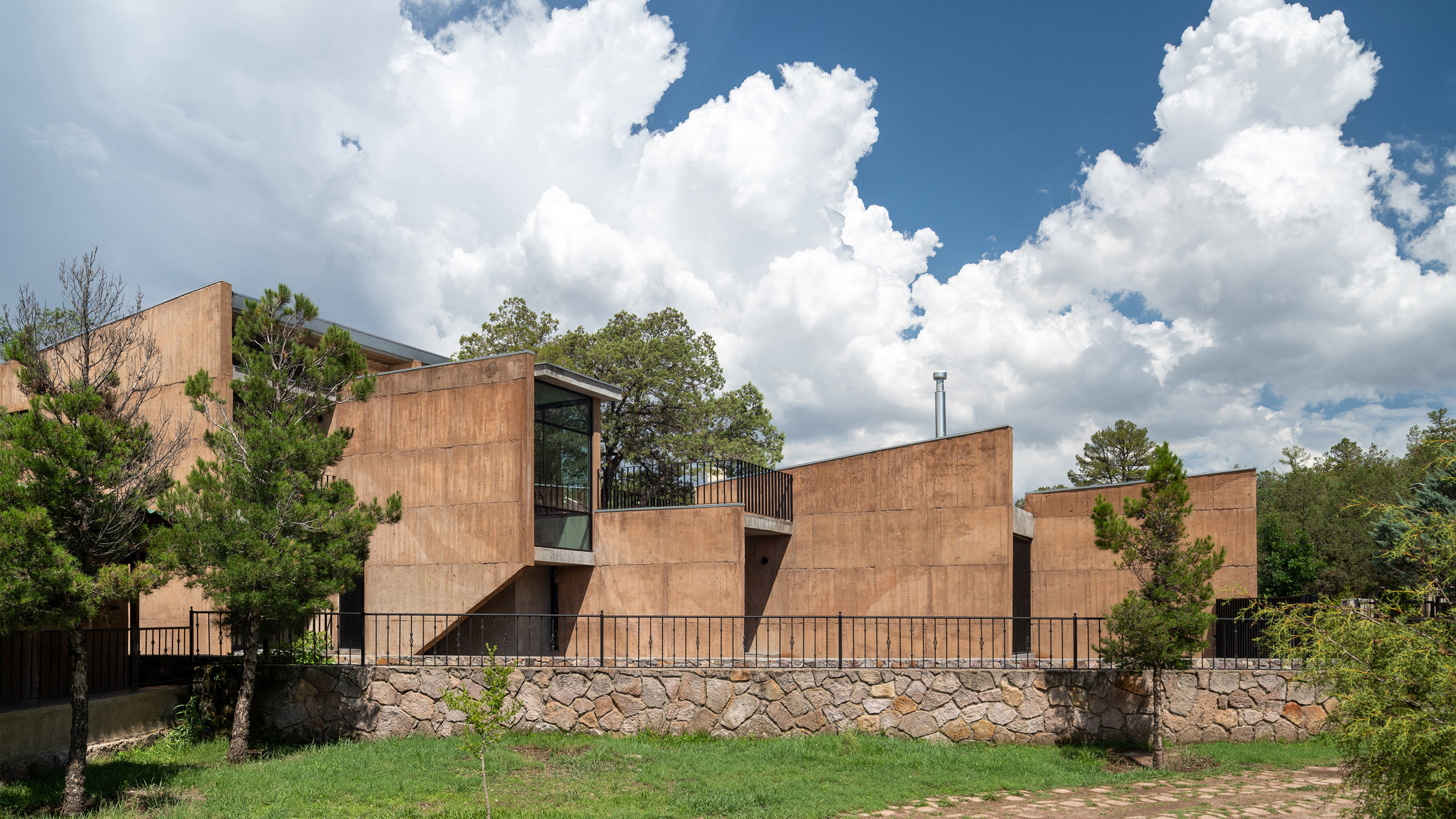 Concrete walls frame desert views in remote Chihuahua home by OAX  Arquitectos