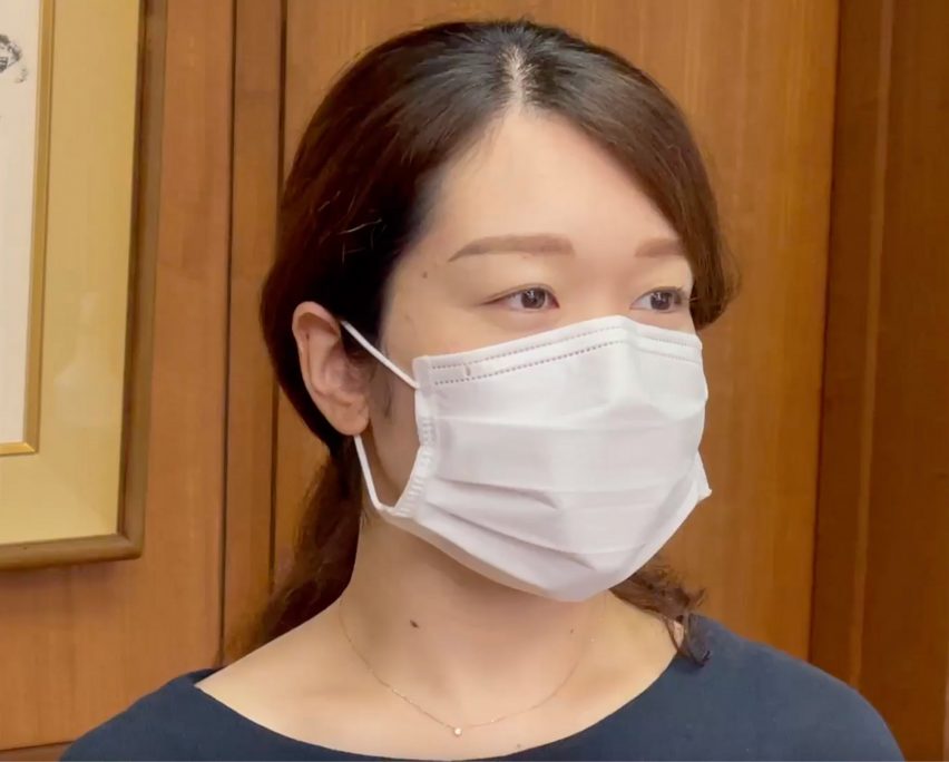 A woman wearing a white face mask