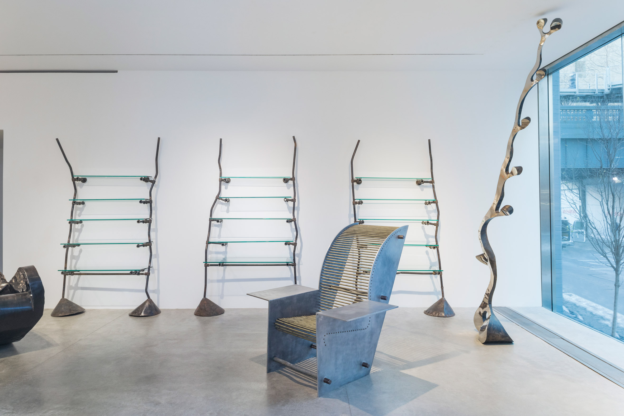 An armchair and ladders inside an exhibition at Friedman Benda