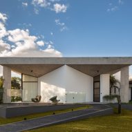 Light wells puncture roof of concrete house in Brasília by Debaixo do Bloco Arquitetura