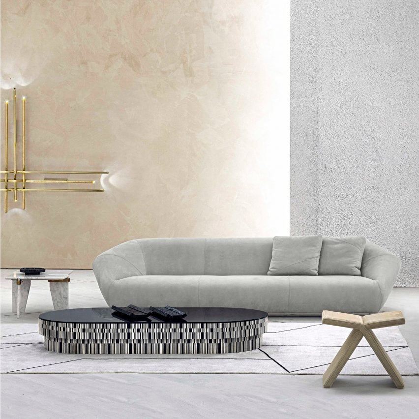 Enigma coffee table by Hessentia set in a room with a sofa and side table