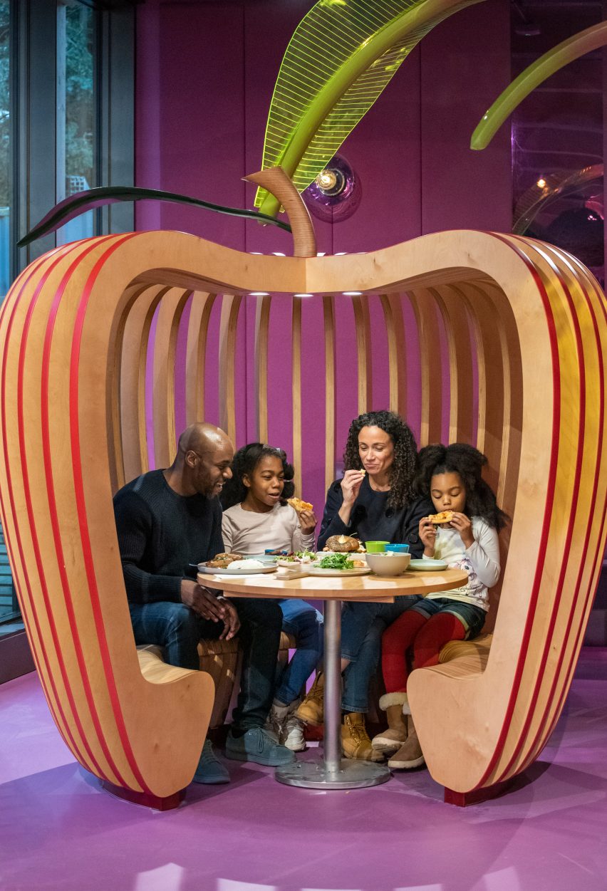A family sitting in a wooden apple seat