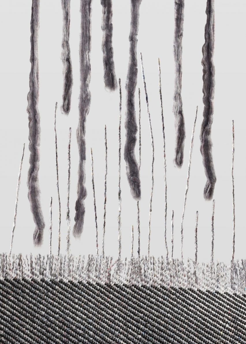 Strings of soft grey yarn merge into the fringe of a rug