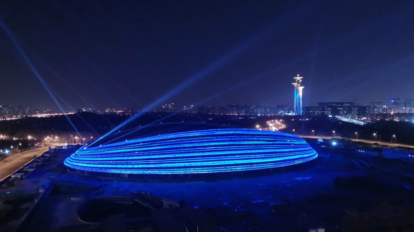 Illuminated exterior of Ice Ribbon by Populous for Beijing 2022 Winter Olympics