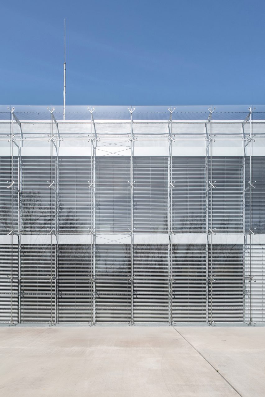 Image of the glass facade in front of slatted shades