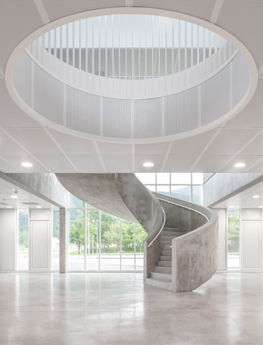 Interior image of the foyer with a concrete staircase at the centre