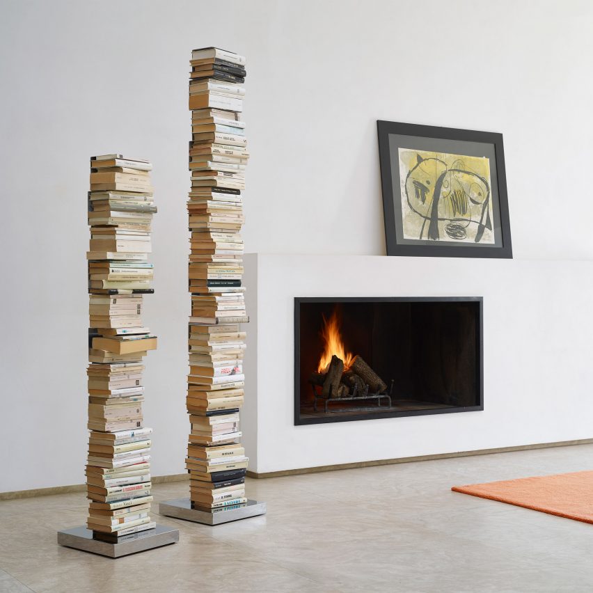Two Ptolomeo book shelves filled with books with a modern fireplace in the background