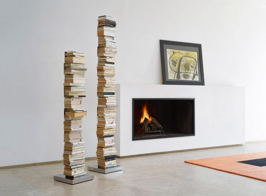 Two Ptolomeo book shelves filled with books with a modern fireplace in the background.