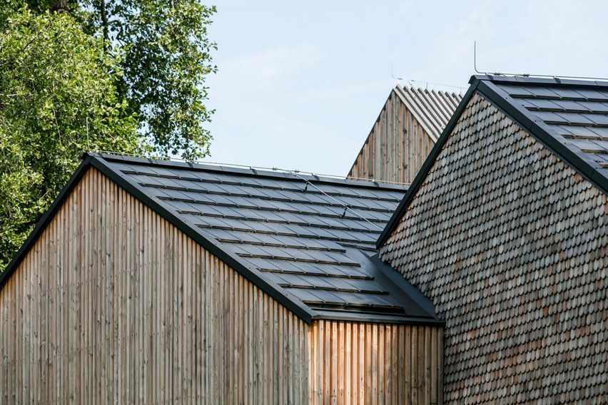 Three gabled roofs one wooden barn-like building