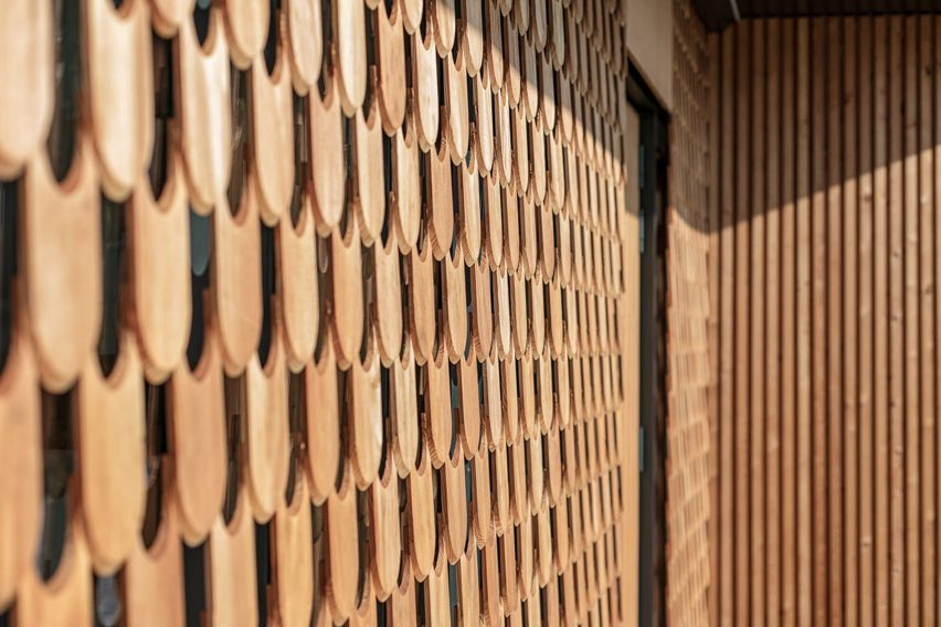 Close-up detail of scalloped tile-like decorative wood cladding on one section of BXB Studio's Polish Farmhouse