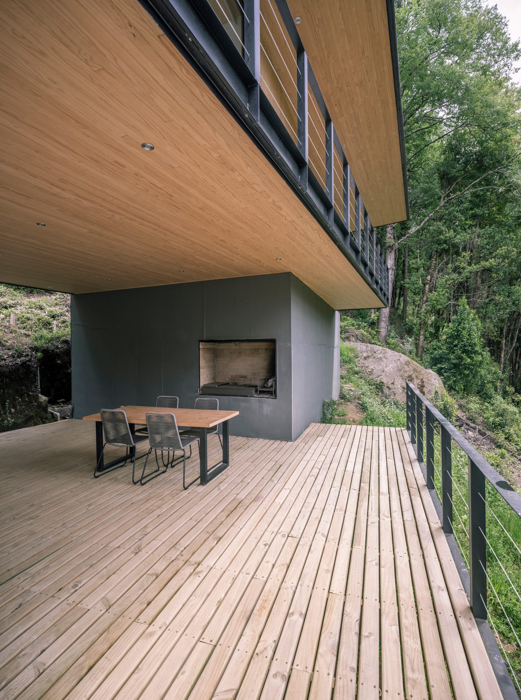 A wooden terrace surrounding PR House