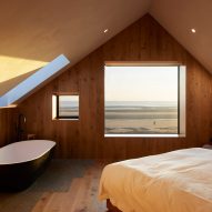 Bedroom with wood-clad walls