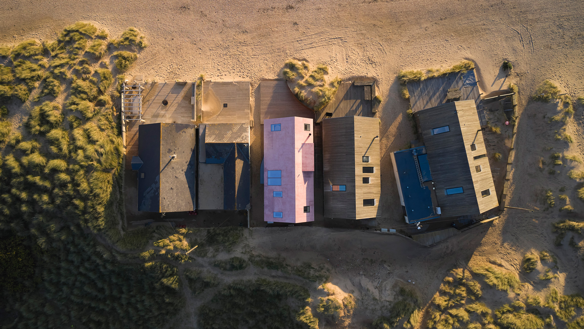 Pink concrete covers RX Architects' "fun house" on the English coast.