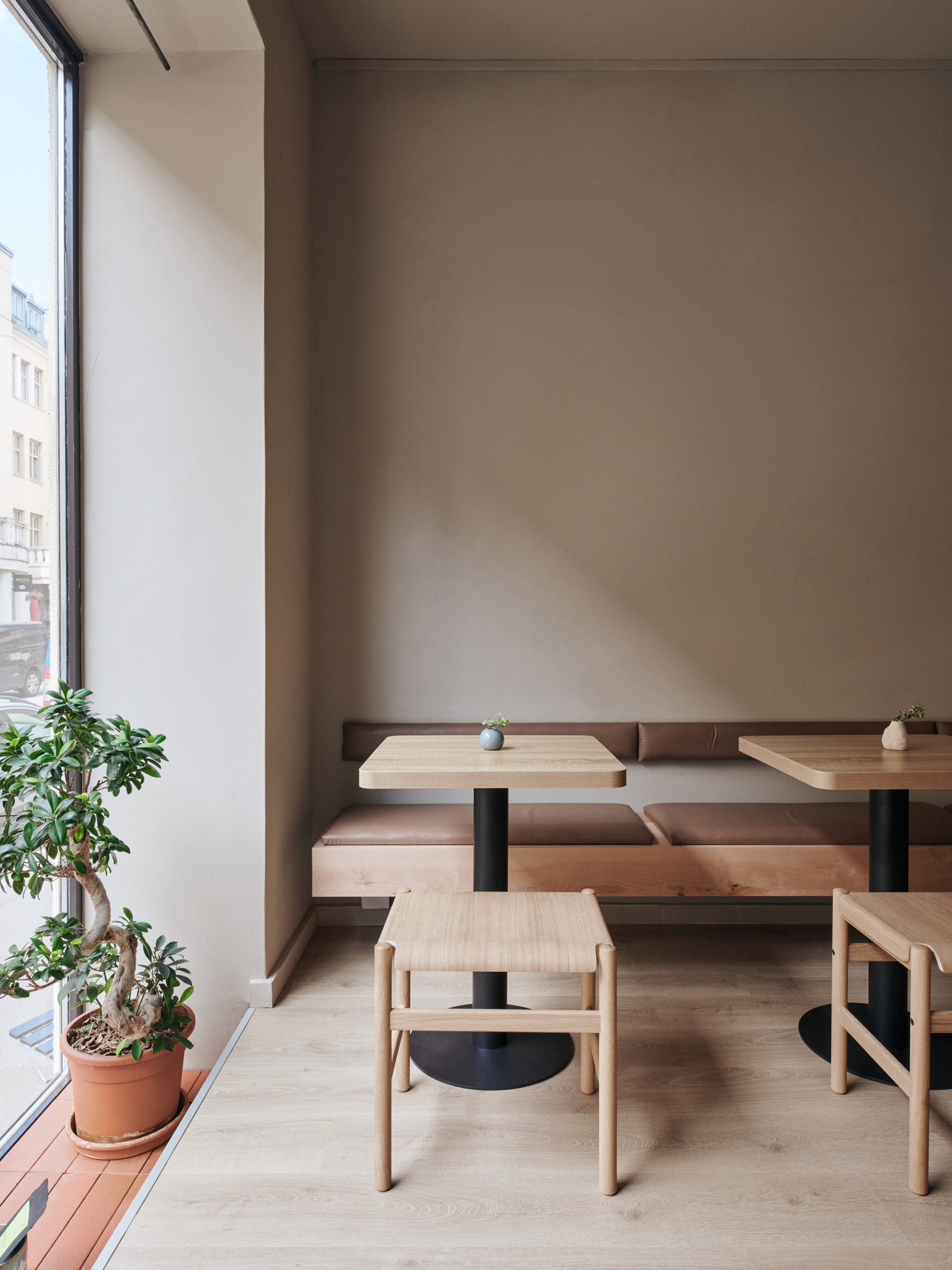 Seating area of teahouse designed by Yatofu with oak bench, table and low stool 