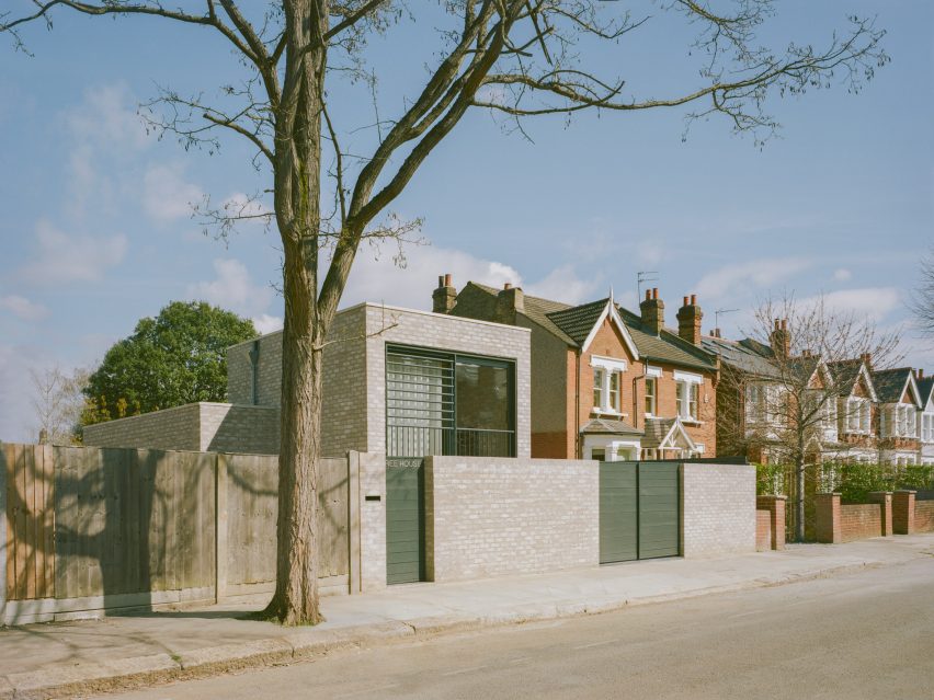 Photograph of a house made of grey brick next to a tree in London by Fletcher Crane Architects
