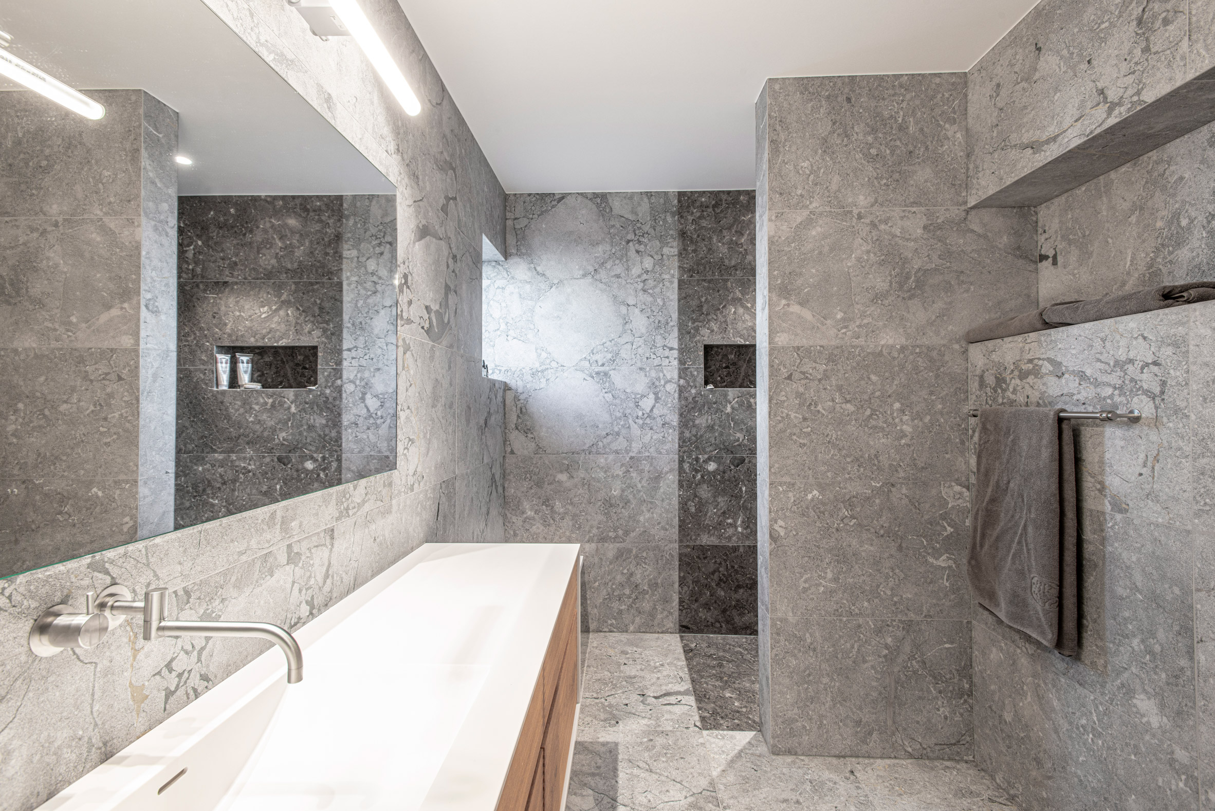 Natural stone bathroom in Villa E by CF Møller Architects