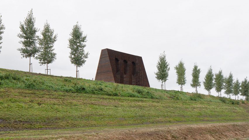 Trees are planted beside the steel monument