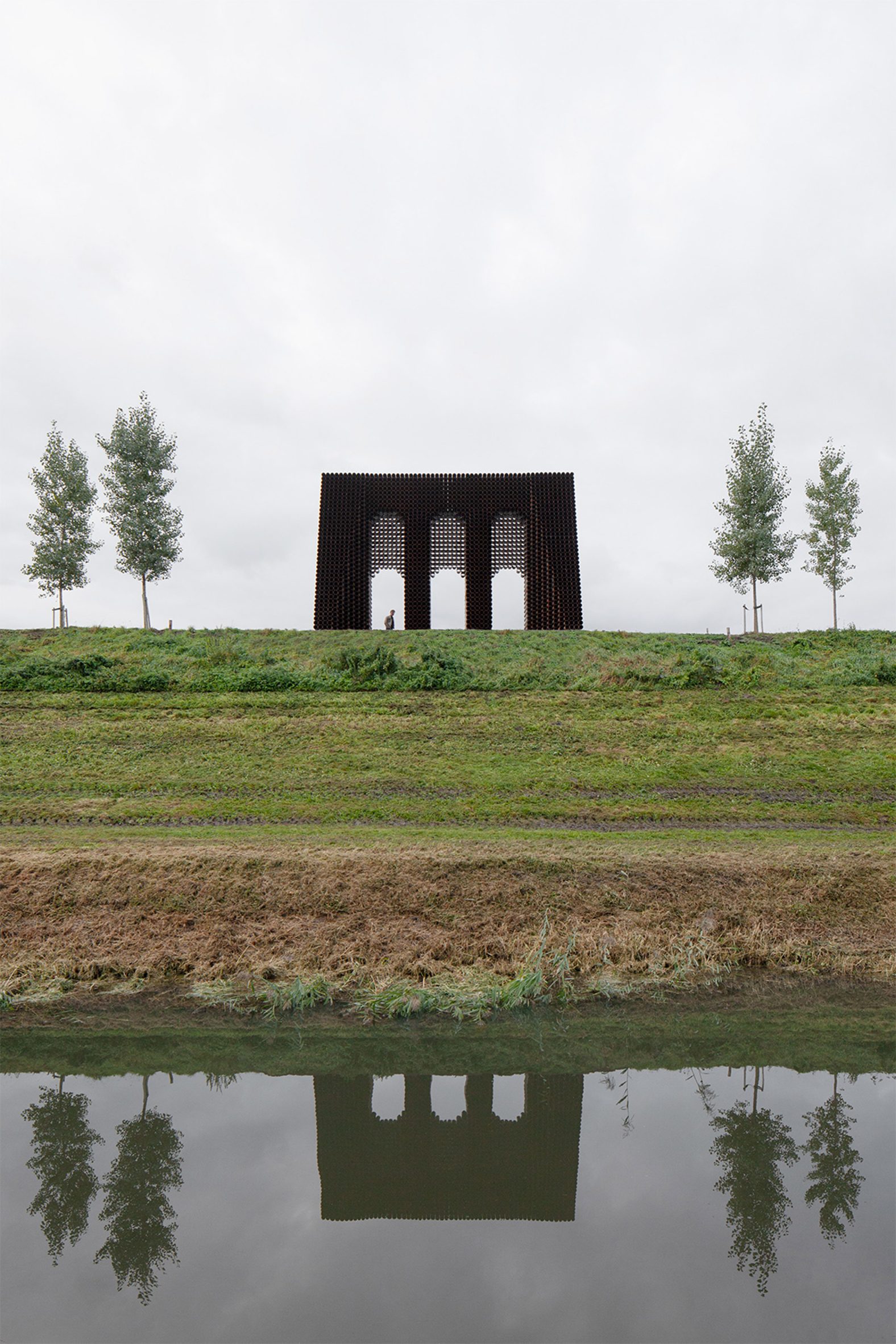 The Waterline Monument by Gijs Van Vaerenbergh is on top of a bank