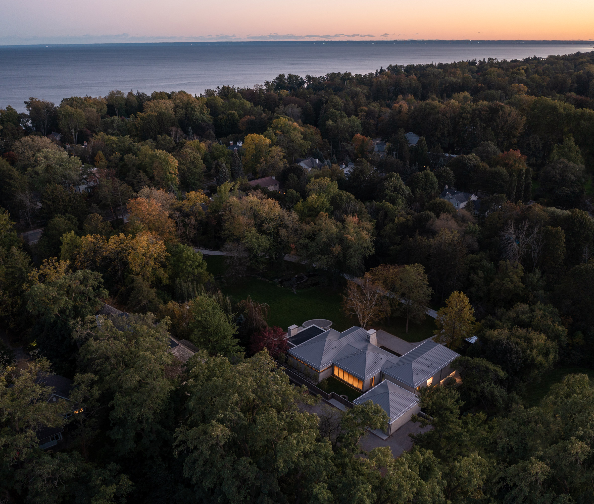 Aerial view of house, woodland and Lake Ontario